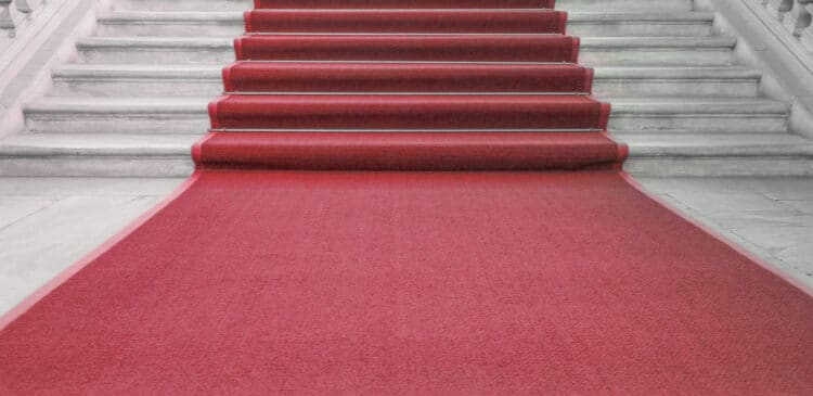 A red carpet on a marble staircase